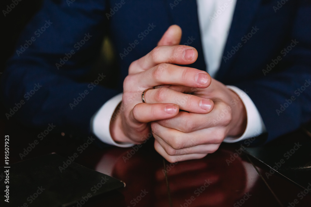 Obraz premium hands with the groom's