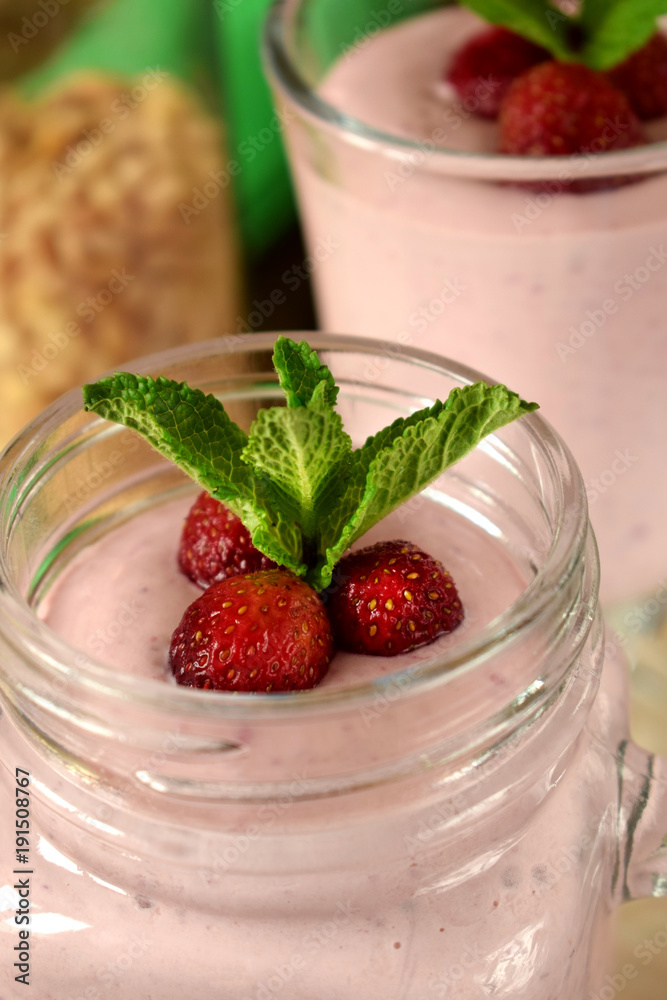 Protein cocktail with strawberries and mint in a glass jar Protein cocktail with strawberries and mint in a glass jar