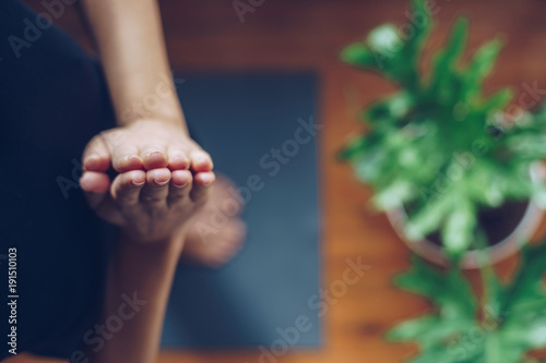 Young woman doing yoga in the morning at her home, top view © SianStock
