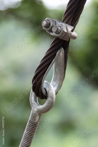 Closeup image of steel guy wire fittings installation.