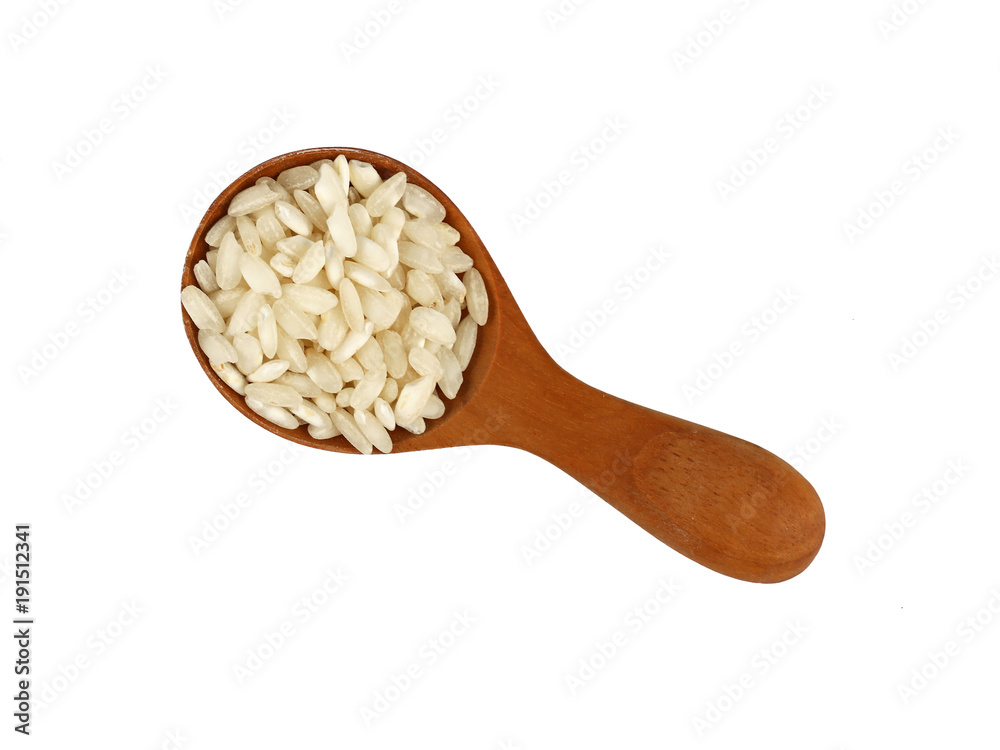 White Arborio rice in wooden scoop on white White Arborio rice in wooden scoop on white