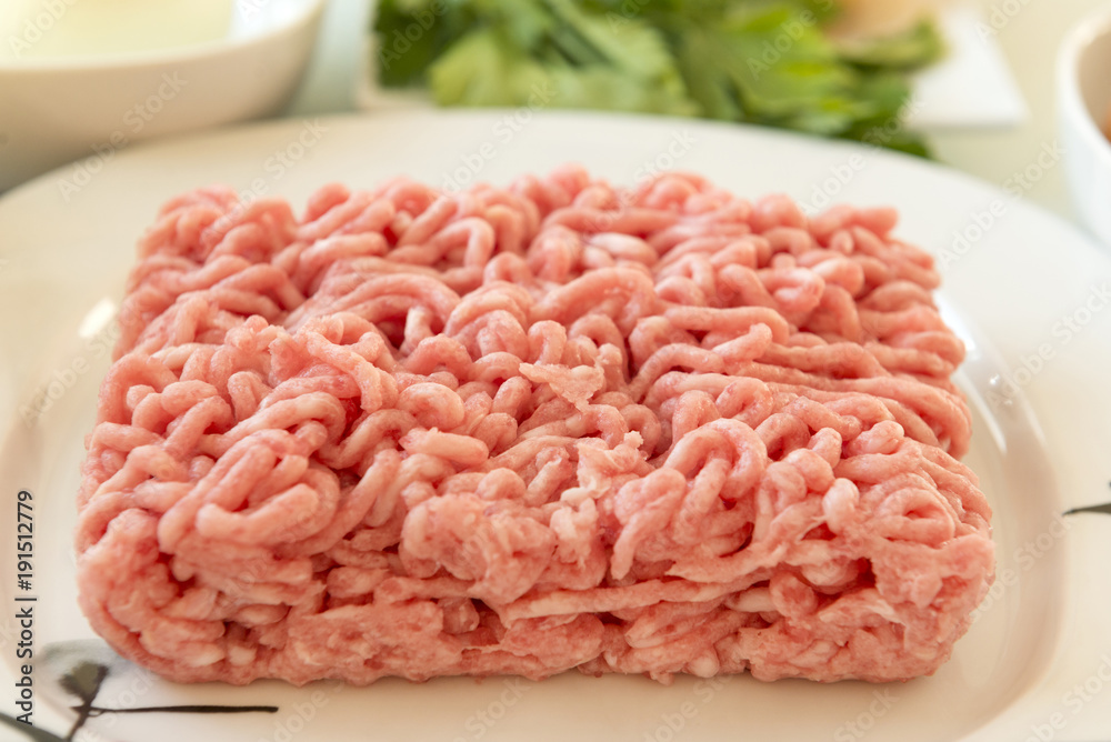 pork minced meat on a plate, ingredients for cooking meat cutlets, food