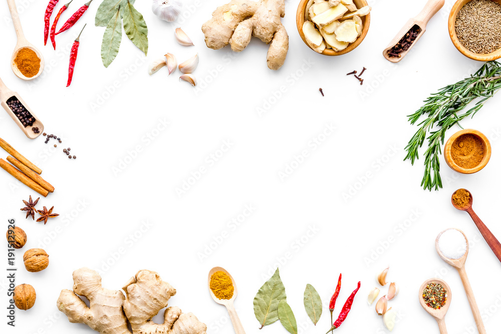 Colorful dry spices in bowls and spoons near ginger, garlic, rosemary on white background top view copy space - obrazy, fototapety, plakaty 