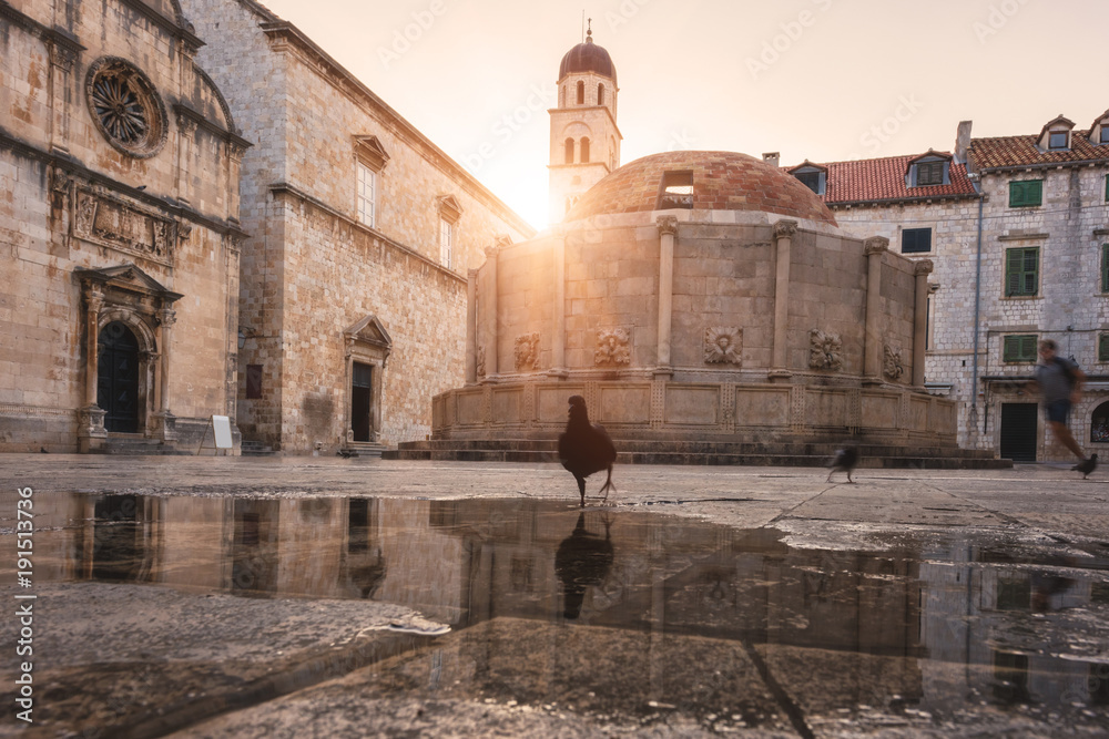 Old City of Dubrovnik. Historical town square with ancient architecture - big Onofrio fountain, church and monastery, popular tourist destination thanks to the fans of the Games of Thrones, Croatia