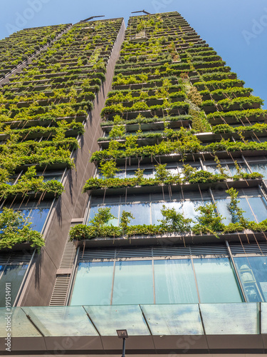 Photography Upward view of building with plants on the facade