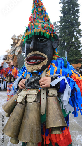 Breznik, Bulgaria - January 20, 2018: Unidentified people with traditional Kukeri costume are seen at the Festival of the Masquerade Games Surova in Breznik, Bulgaria