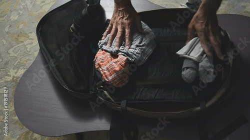 man packing suitcase