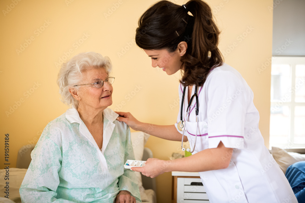 Fototapeta premium Old senior woman waiting nurse to bring drogs to her