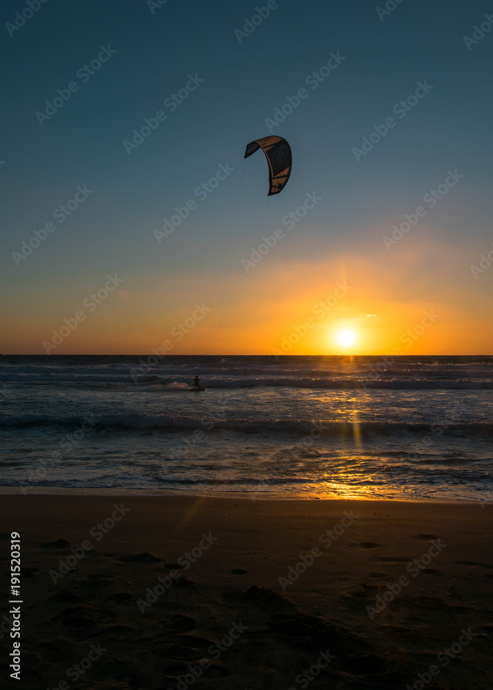 Wind surfer still surfing during the sunset Wind surfer still surfing during the sunset