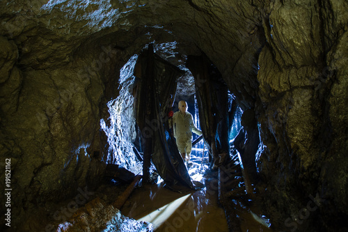 Underground abandoned ore mine shaft tunnel gallery with scary horror monster zombie