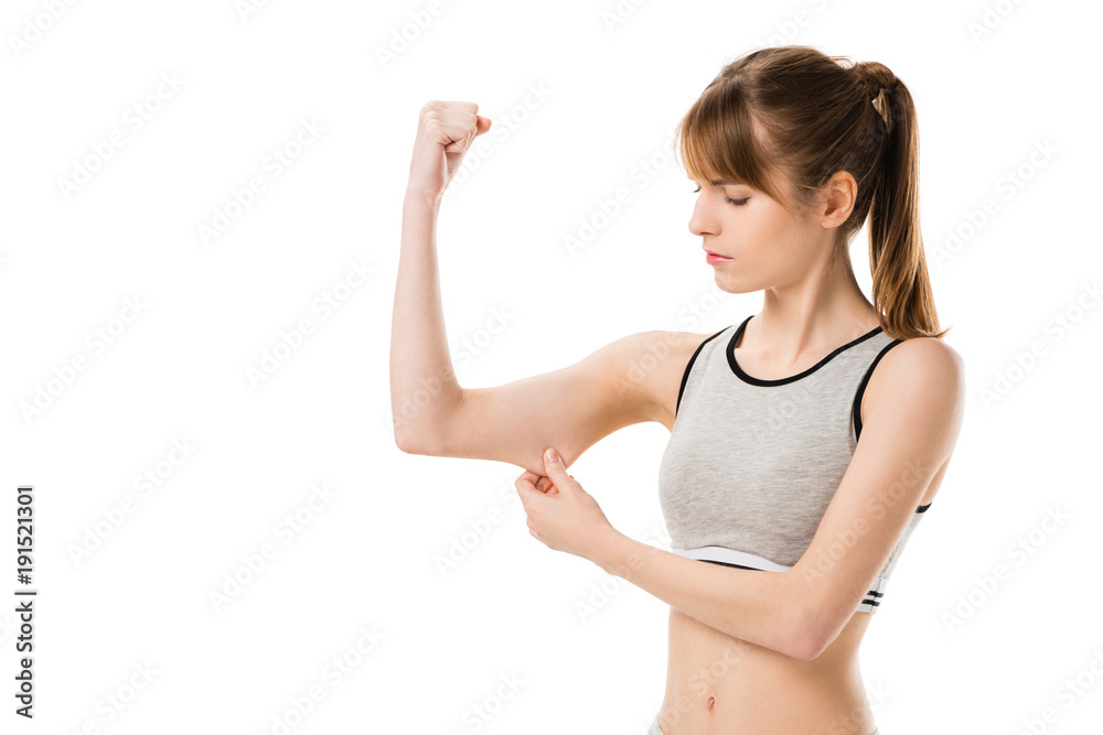 young slim woman showing biceps isolated on white young slim woman showing biceps isolated on white