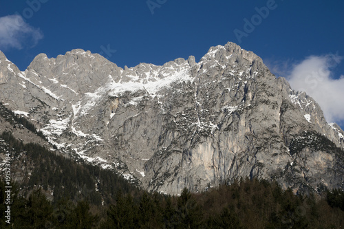 Sun shining on a massive alpine ridge in the mountains of Austria