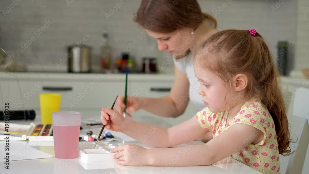 happy family mother and child girl paint paints at home happy family mother and child girl paint paints at home
