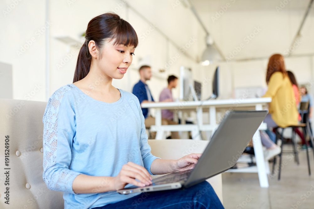 happy asian woman with laptop working at office happy asian woman with laptop working at office