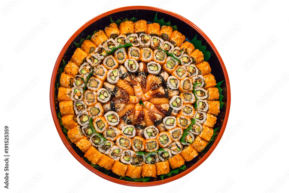 different types of sushi are stacked on a round dish on a white background. A variety of Japanese sushi buns.