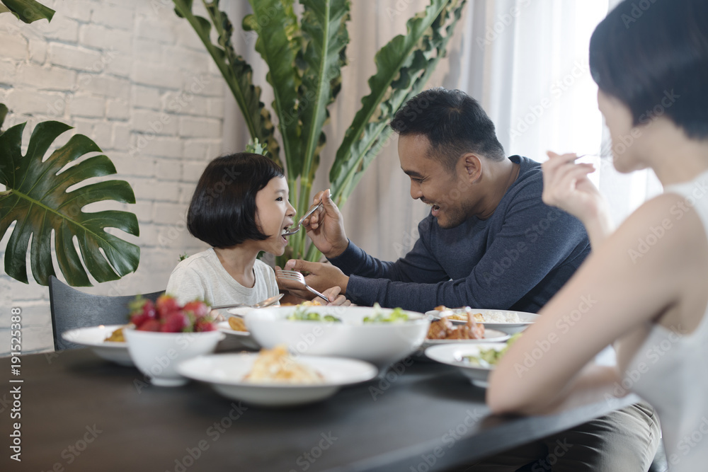 Happy Asian family eating together at home. Happy Asian family eating together at home.