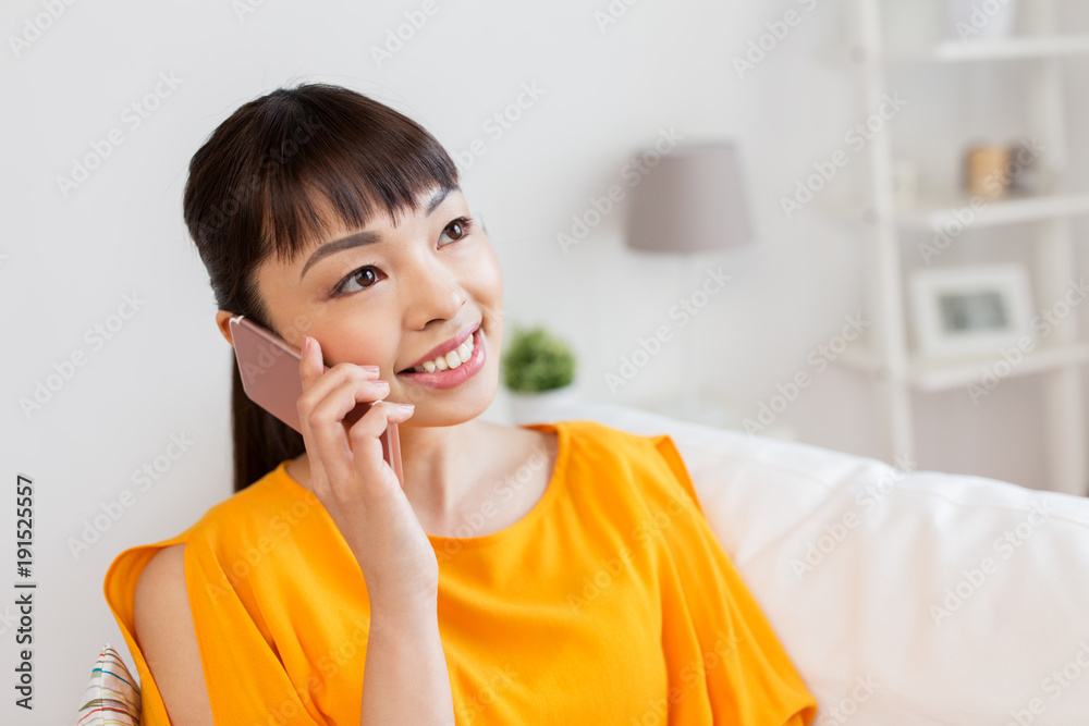 happy asian woman calling on smartphone at home happy asian woman calling on smartphone at home