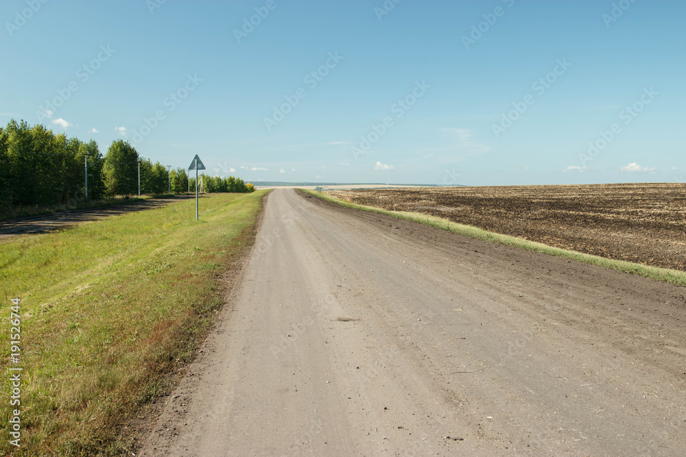 Naklejka premium The road through the countryside.