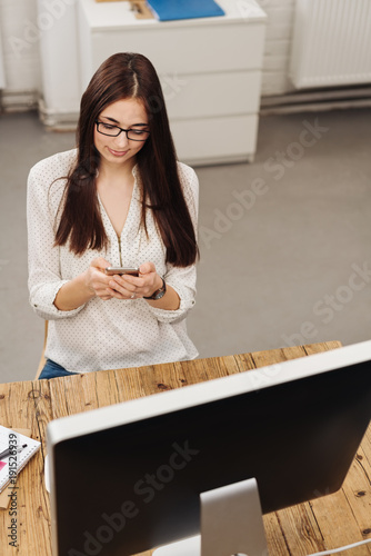 Businesswoman texting on her mobile phone