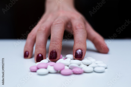 Depression and problem. Hand surrounded by many pills.