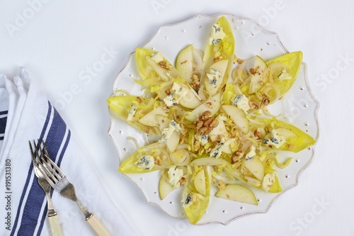 Pear, chicory and blue cheese salad on the white background. Top view, flat lay