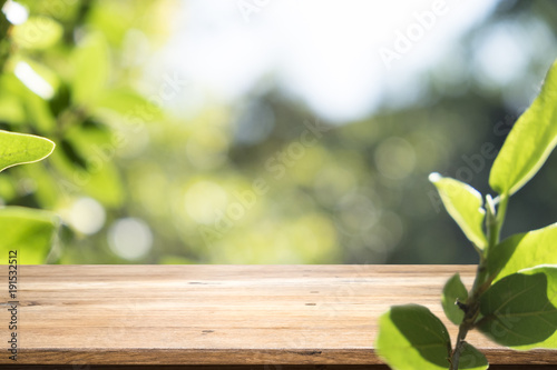 Wooden table with blur background of nature forest.