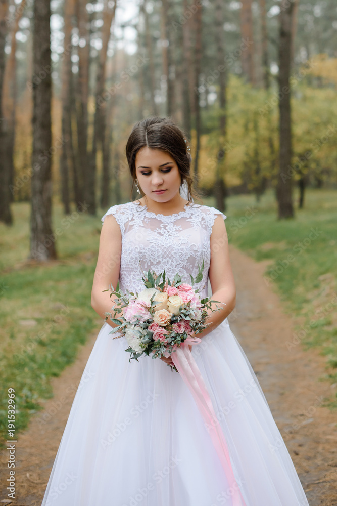happy bride on autumn forest. young beauty bride with big eye