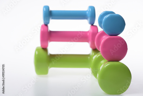 Fit shape and sport concept. Barbells in different size, closeup