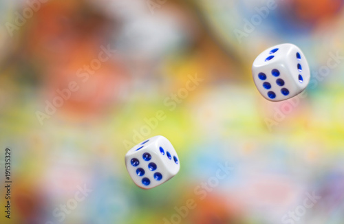 two Rolling dice on blurred colorful background. bone to game. Board games, gaming moments in dynamics. concept of luck, winning, victory photo