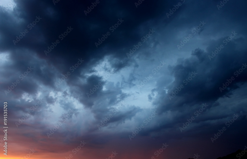 View of great storm on the sky. Delightful stormy sky with amazing dark blue clouds at sunset background