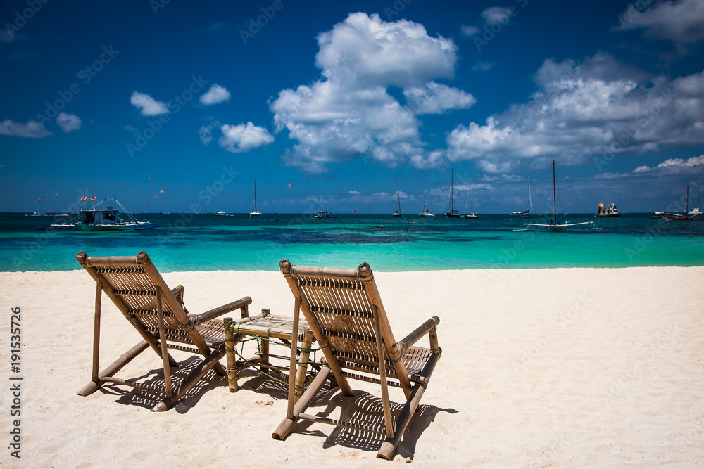Tropical vacation on white sand beach with sun and blue sky at Boracay, Philippines.