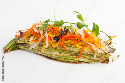 restaurant serving of zucchini with vegetables on a white background