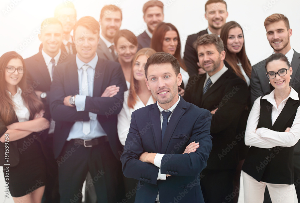 leader standing in front of a large business team leader standing in front of a large business team
