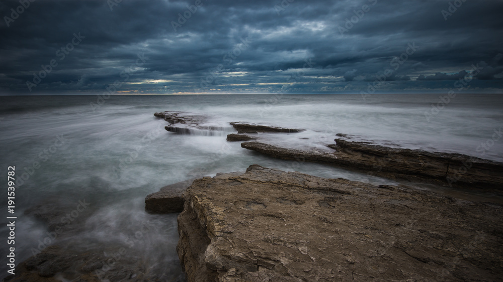 Beautiful rocky beach in the Portuguese coastline in a stormy day. Seascape. Long exposure Beautiful rocky beach in the Portuguese coastline in a stormy day. Seascape. Long exposure