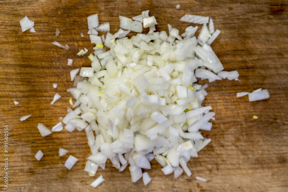 Crumbled white onion on a wooden board Crumbled white onion on a wooden board