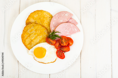 Potato pancakes  fried egg  sausage for breakfast