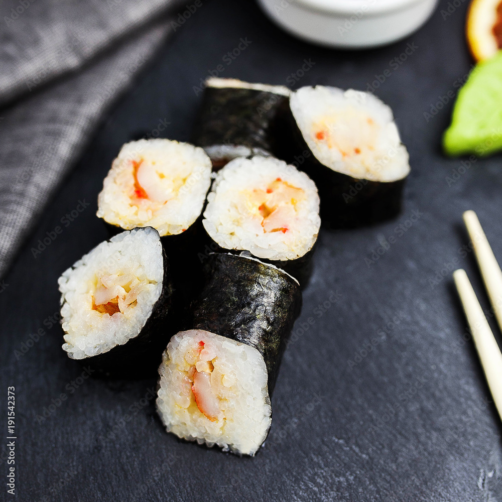 Japanese sushi rolls maki on the graphite board Japanese sushi rolls maki on the graphite board