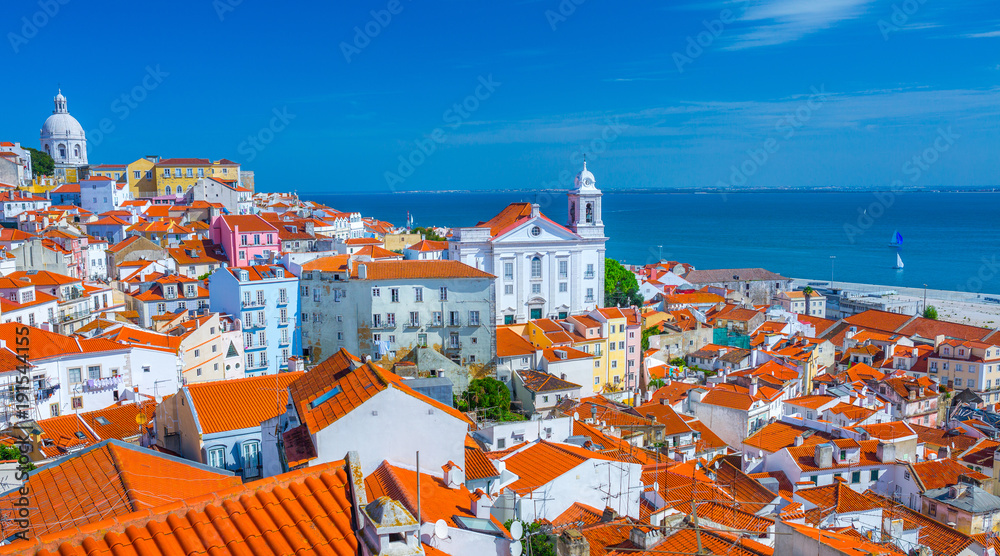 Summertime sunshine day cityscape in the Alfama - historic old district Alfama in Lisbon, Portugal. - obrazy, fototapety, plakaty 