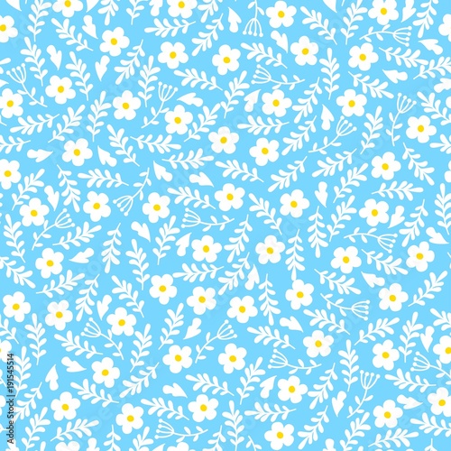 Seamless background of small daisies leaves on a blue background. Pattern for fabric, wrapping paper and scrapbooking
