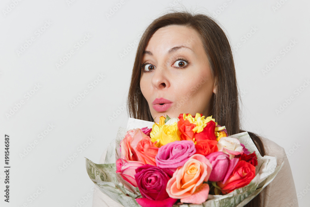 Close up young woman holding bouquet of beautiful roses flowers isolated on white background. Copy space for advertisement. With place for text. St. Valentines Day or International Women's Day concept Close up young woman holding bouquet of beautiful roses flowers isolated on white background. Copy space for advertisement. With place for text. St. Valentines Day or International Women's Day concept