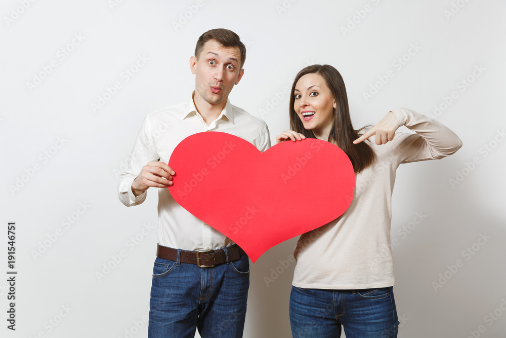 Couple in love. Man and woman with big red heart isolated on white background. Copy space for advertisement. With place for text. St. Valentine's Day International Women's Day birthday holiday concept