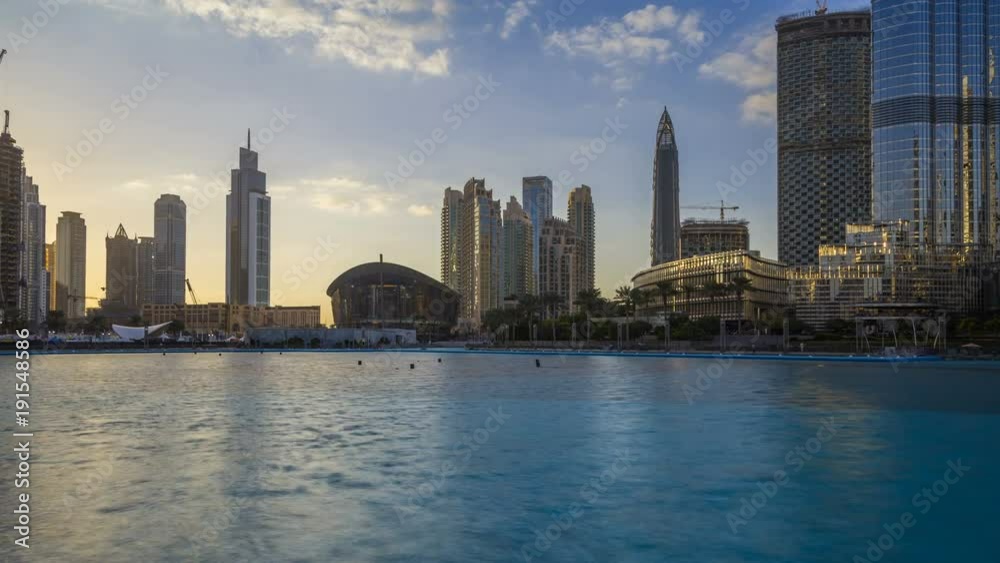 Timelapse of downtown Dubai skyline, view from the Dubai fountain to the Opera Theatre. Modern city cityscape with skyscrapers. Dubai, UAE. Timelapse of downtown Dubai skyline, view from the Dubai fountain to the Opera Theatre. Modern city cityscape with skyscrapers. Dubai, UAE.