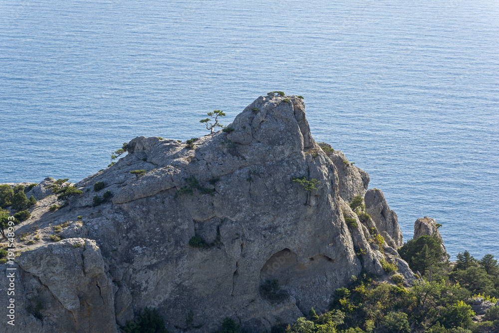 Coastal rocks against the background of the sea. Coastal rocks against the background of the sea.