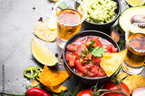 Latinamerican food party sauce guacamole  salsa  chips and tequi