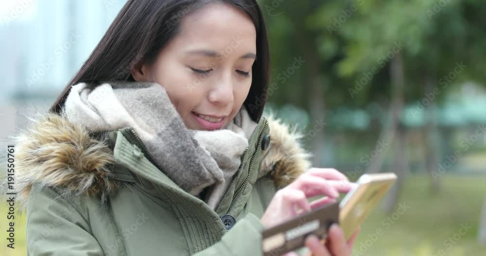 Woman use of mobile phone for online shopping at outdoor Woman use of mobile phone for online shopping at outdoor