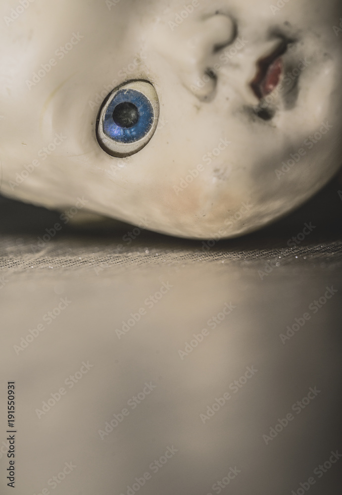 Fototapeta premium Half face portrait of old doll with one blue eye.