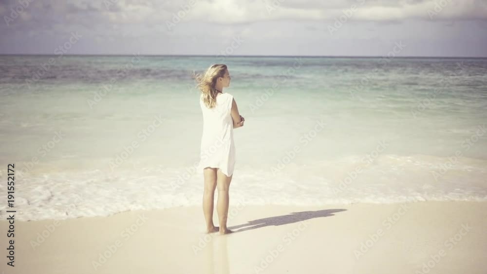 young caucasian woman staring at the sea and relaxing on her vacation in the Caribbean sea, on the sunny coast of cuba, having a happy carefree day on the beach young caucasian woman staring at the sea and relaxing on her vacation in the Caribbean sea, on the sunny coast of cuba, having a happy carefree day on the beach