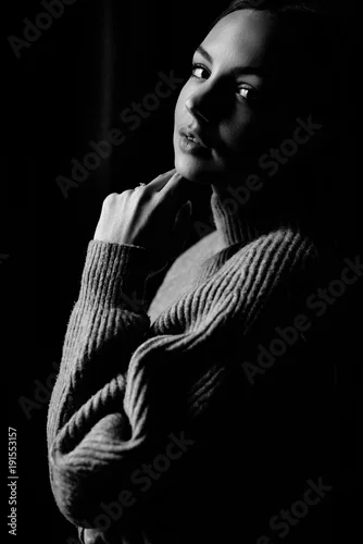 Obraz Very beautiful and sincere black and white portrait of an attractive girl on which shines the light from the window