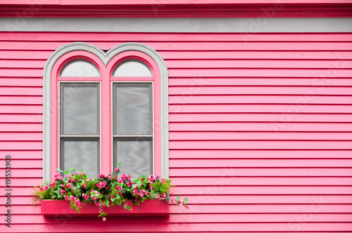 Arched Windows on a Colorful Pink House with Flower Boxes