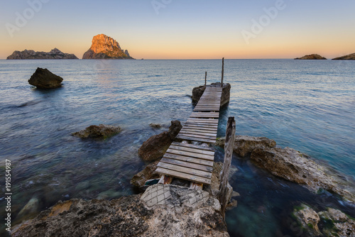 Small wooden pier in Cala d Hort beach  Es Vedra as background  Ibiza island  Spain